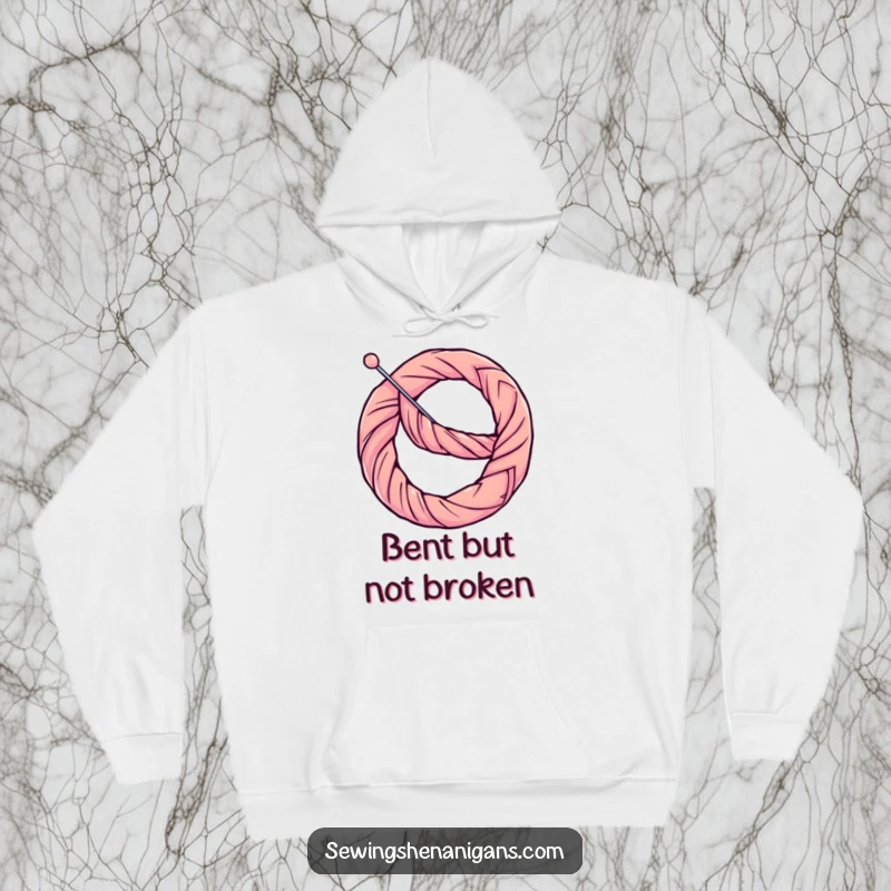 Funny Hoodie: A determined thread lovingly bends a needle into a pretzel shape, creating a comical sewing scene.