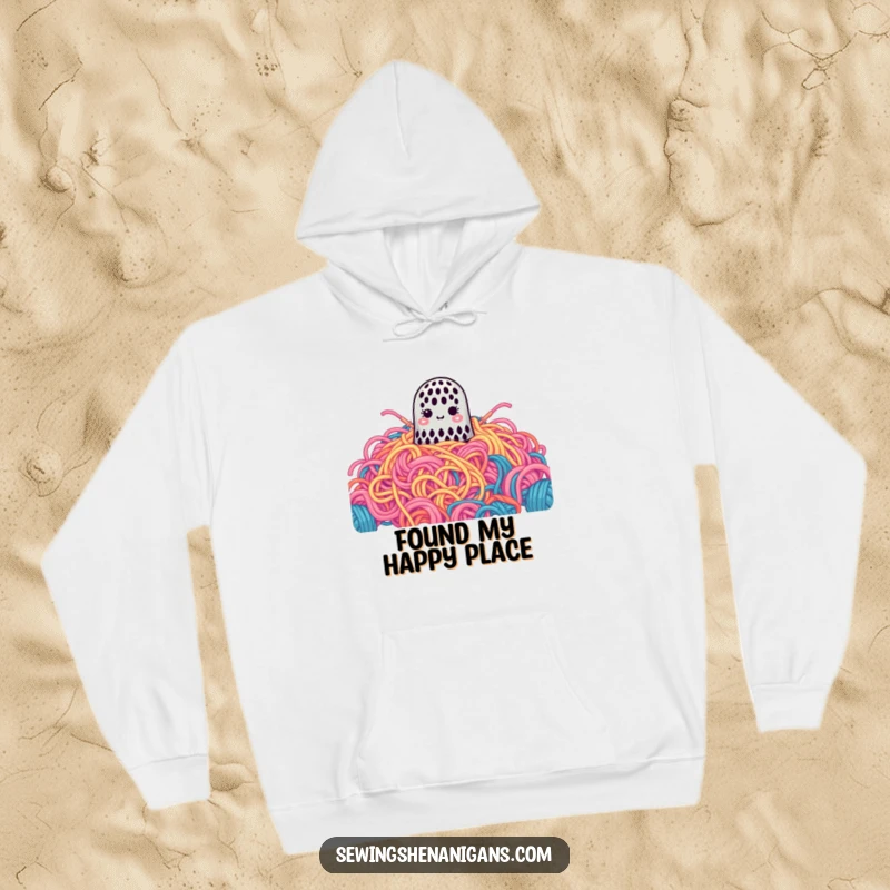 Funny Hoodie: A cute thimble gets lost in a gigantic pile of colorful yarn, bringing cozy humor.