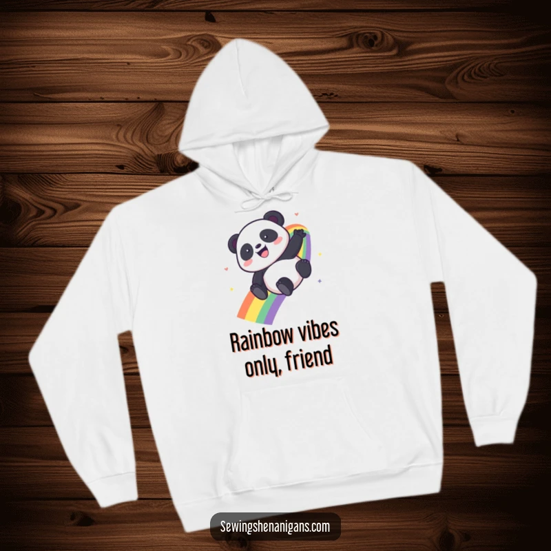 Funny Kawaii Panda hoodie featuring a panda gleefully descending a colorful rainbow, exuding pure happiness and fun.