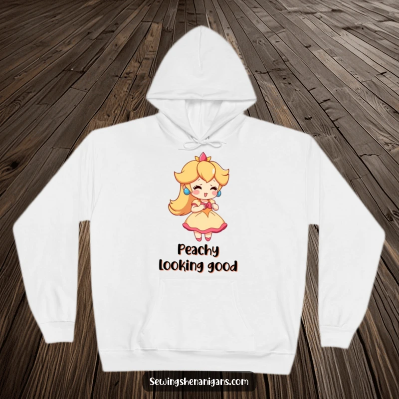 Funny Peach Dress Hoodie: A playful peach character enthusiastically trying on a tiny dress, perfect for a funny and cozy gift.