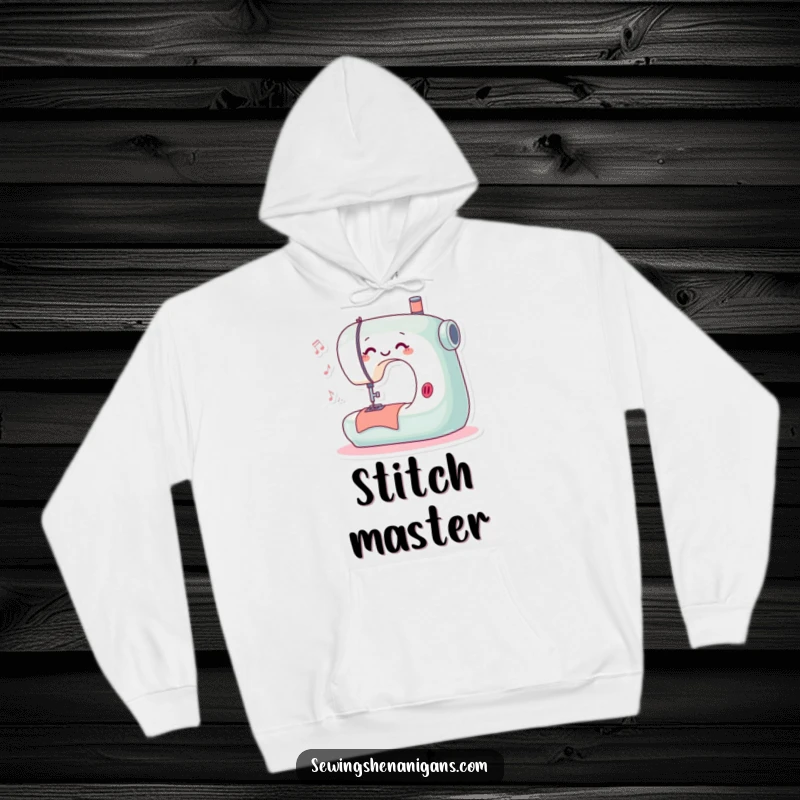 Funny hoodie showcasing a playful sewing machine character happily stitching and humming, perfect for comfortable and creative endeavors.