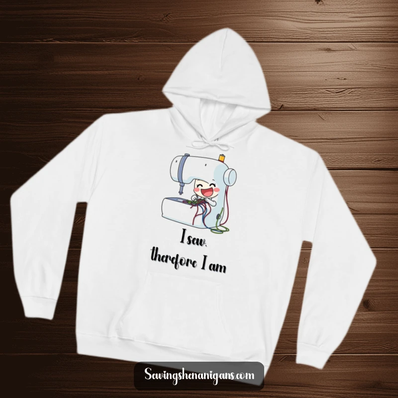 Funny sewing machine hoodie featuring a delighted character stitching threads, offering warmth and humor for crafters and as a great funny gift.