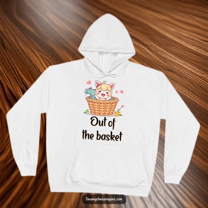 Funny Sewing Basket Hoodie: A character pops joyfully from a sewing basket, ideal for staying warm and crafty.