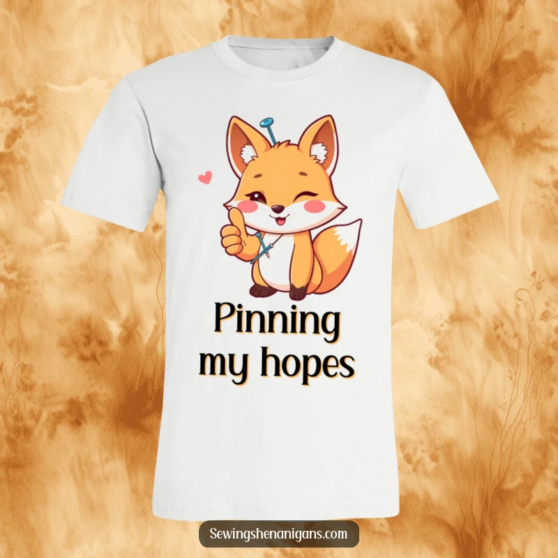 Funny happy fox wearing a sewing pin, giving a thumbs up, depicted on a t-shirt, a fun and crafty funny gift.