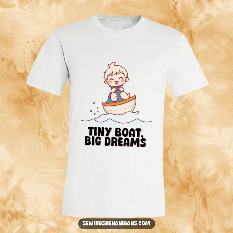 Funny t-shirt featuring a giggling character riding a thimble like a miniature boat, humorously crossing a fabric surface.