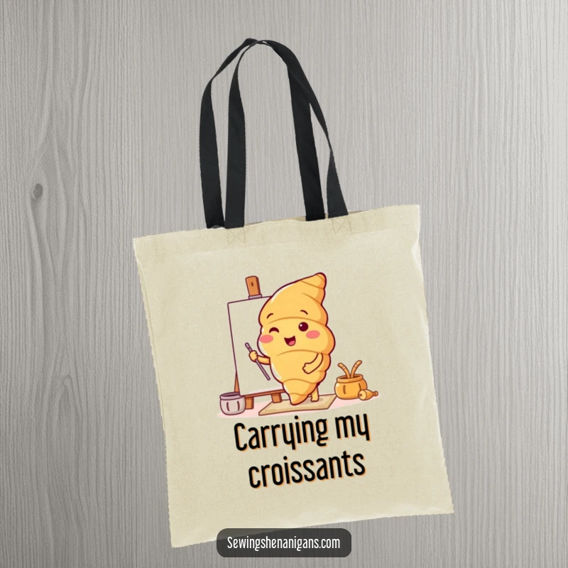 Funny tote bag with a cheerful croissant character enthusiastically trying out a new, unique pattern, ideal for shopping.